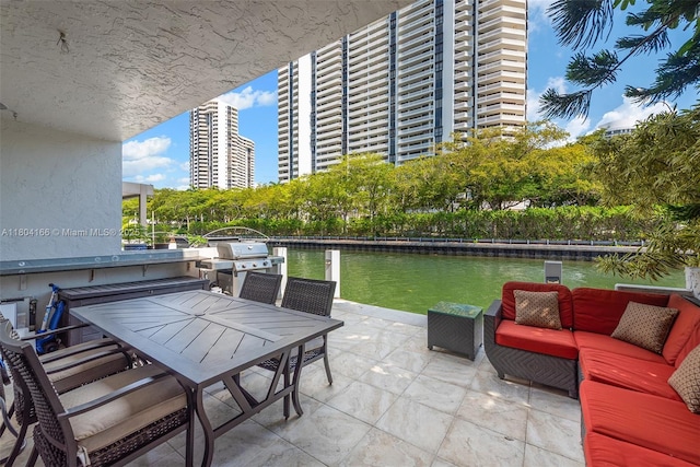 3553 NE 171st St Unit P, North Miami Beach, FL 33160 - view of patio / terrace featuring a water view, area for grilling, and outdoor dining area