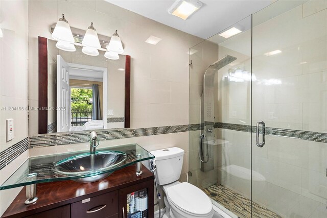 3553 NE 171st St Unit P, North Miami Beach, FL 33160 - full bath featuring a stall shower, toilet, tile walls, and vanity