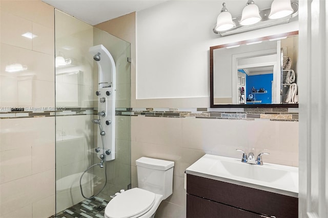 3553 NE 171st St Unit P, North Miami Beach, FL 33160 - full bathroom with a stall shower, tile walls, toilet, and vanity
