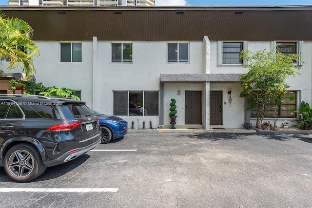 3553 NE 171st St Unit P, North Miami Beach, FL 33160 - view of front facade with stucco siding and uncovered parking