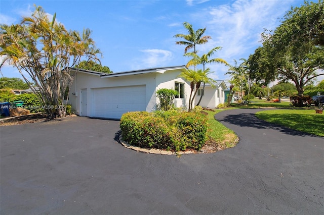 17640 SW 84th Ct, Palmetto Bay, FL 33157 - view of front of property featuring driveway, stucco siding, an attached garage, and a front lawn