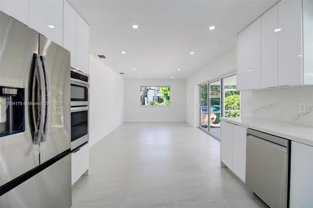 17640 SW 84th Ct, Palmetto Bay, FL 33157 - kitchen featuring stainless steel appliances, modern cabinets, white cabinetry, recessed lighting, and decorative backsplash