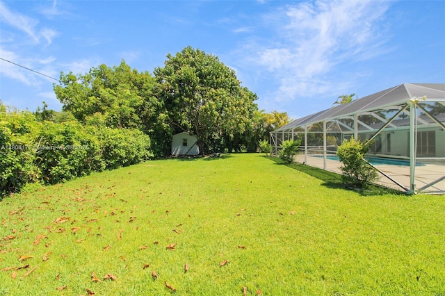 17640 SW 84th Ct, Palmetto Bay, FL 33157 - view of grassy yard with a storage shed, an outdoor pool, an outbuilding, and a lanai