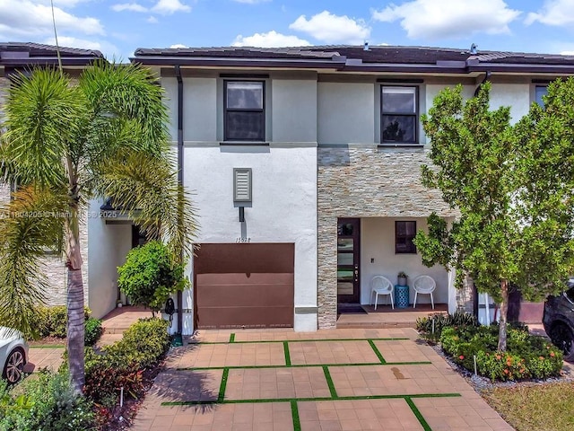 15678 NW 91st Ct, Miami Lakes, FL 33018 - townhome / multi-family property with stucco siding, stone siding, and a garage