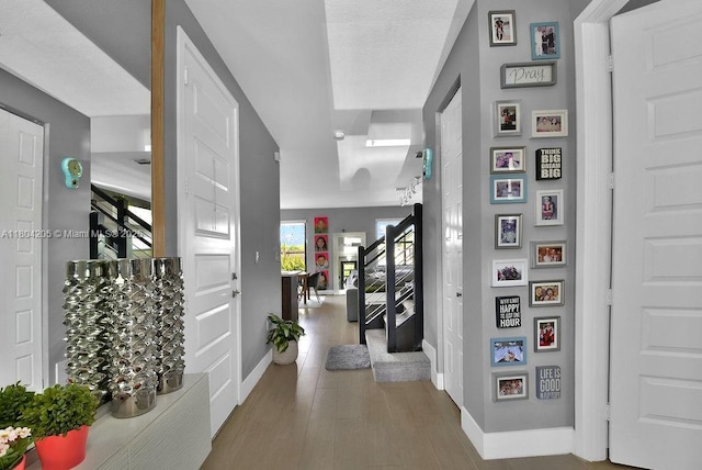 15678 NW 91st Ct, Miami Lakes, FL 33018 - hallway with baseboards, stairway, and wood finished floors