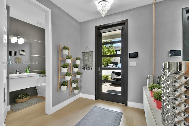 15678 NW 91st Ct, Miami Lakes, FL 33018 - entrance foyer with light wood-style floors and baseboards