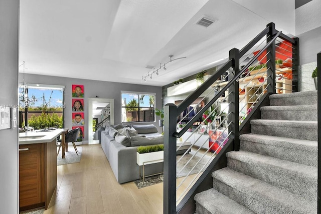 15678 NW 91st Ct, Miami Lakes, FL 33018 - living room with rail lighting, plenty of natural light, stairway, and light wood finished floors