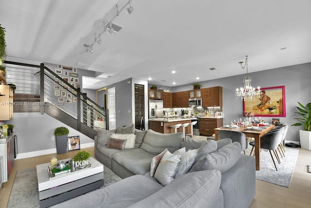 15678 NW 91st Ct, Miami Lakes, FL 33018 - living area featuring stairway, light wood finished floors, baseboards, a chandelier, and recessed lighting