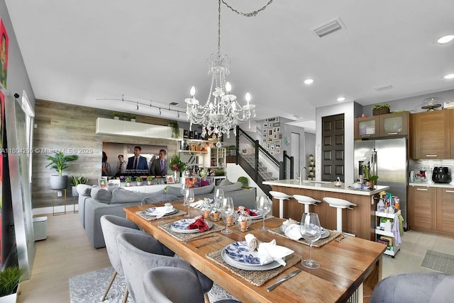 15678 NW 91st Ct, Miami Lakes, FL 33018 - dining area with stairs, a chandelier, recessed lighting, and wooden walls