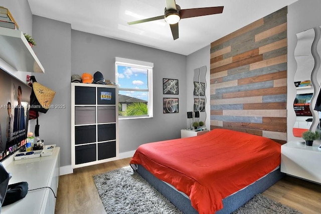 15678 NW 91st Ct, Miami Lakes, FL 33018 - bedroom with wood finished floors, wood walls, a ceiling fan, and baseboards
