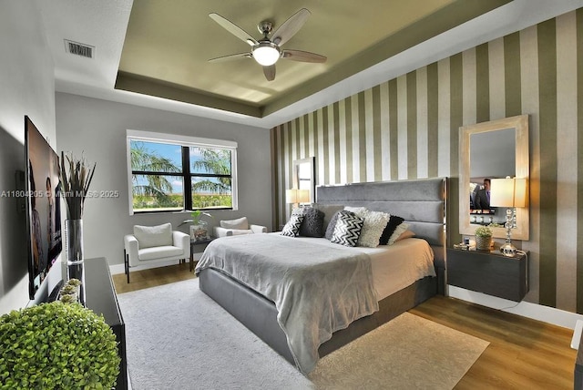 15678 NW 91st Ct, Miami Lakes, FL 33018 - bedroom featuring a tray ceiling, wood finished floors, baseboards, and a ceiling fan