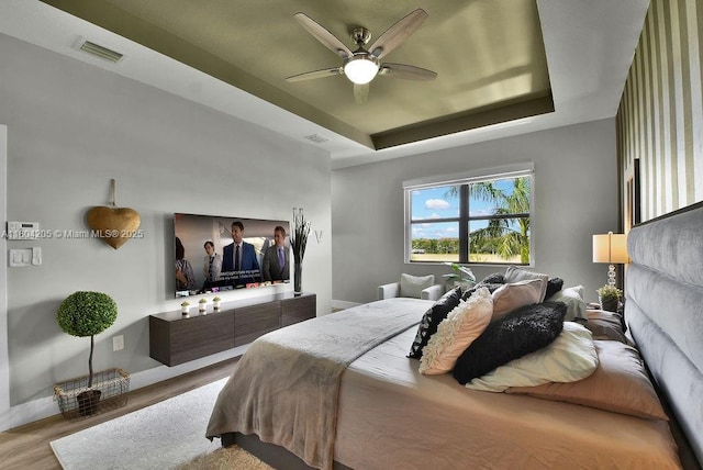 15678 NW 91st Ct, Miami Lakes, FL 33018 - bedroom featuring wood finished floors, a raised ceiling, ceiling fan, and baseboards
