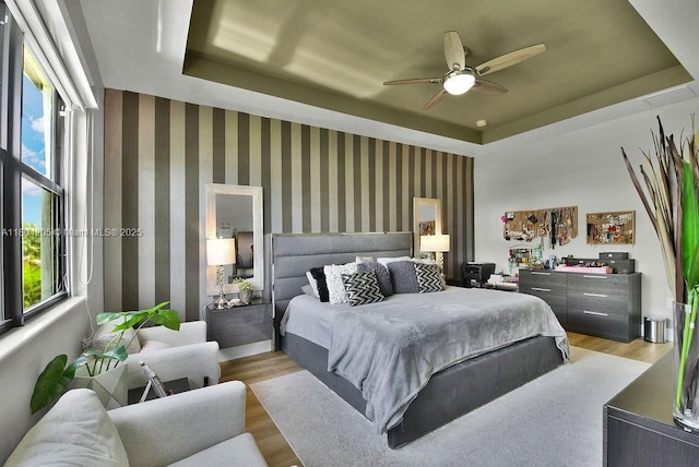 15678 NW 91st Ct, Miami Lakes, FL 33018 - bedroom with a raised ceiling, multiple windows, wood finished floors, and ceiling fan