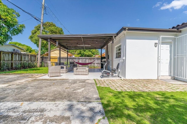 8000 SW 36th St, Miami, FL 33155 - view of patio featuring a fenced backyard, an outdoor living space, and a carport