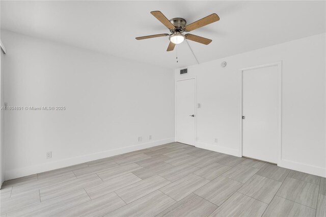 3401 Bimini Ln Unit E1, Coconut Creek, FL 33066 - unfurnished bedroom with a ceiling fan, light wood-style floors, and baseboards
