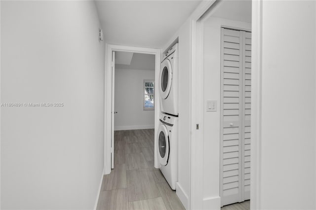 3401 Bimini Ln Unit E1, Coconut Creek, FL 33066 - washroom featuring stacked washing machine and dryer and baseboards
