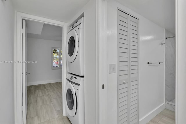 3401 Bimini Ln Unit E1, Coconut Creek, FL 33066 - laundry room with estacked washer and dryer and baseboards