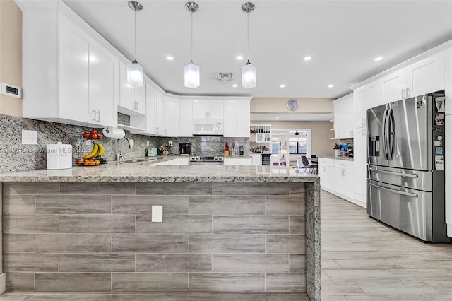 10350 SW 30th St, Miami, FL 33165 - kitchen with stainless steel appliances, a peninsula, a sink, light stone countertops, and recessed lighting