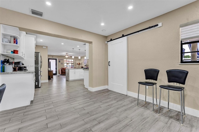 10350 SW 30th St, Miami, FL 33165 - living area with a barn door, baseboards, light wood-style flooring, and recessed lighting