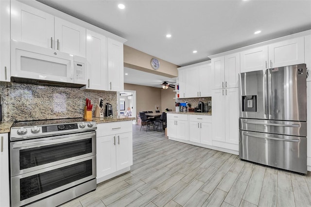 10350 SW 30th St, Miami, FL 33165 - kitchen with stainless steel appliances, decorative backsplash, white cabinetry, light wood finished floors, and recessed lighting