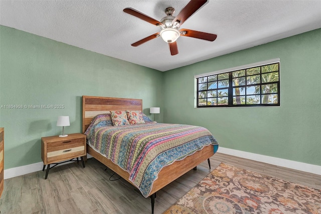 10350 SW 30th St, Miami, FL 33165 - bedroom featuring baseboards, wood finished floors, a textured ceiling, and a ceiling fan
