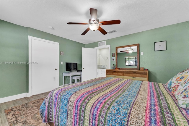 10350 SW 30th St, Miami, FL 33165 - bedroom featuring wood finished floors, baseboards, a ceiling fan, and ensuite bathroom