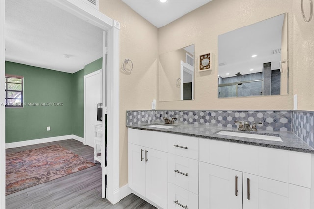 10350 SW 30th St, Miami, FL 33165 - full bathroom with wood finished floors, double vanity, a shower, and baseboards