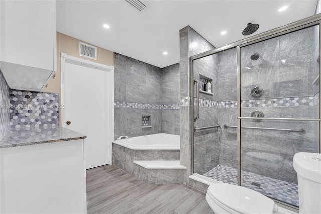 10350 SW 30th St, Miami, FL 33165 - bathroom with toilet, a shower stall, a garden tub, recessed lighting, and wood finished floors