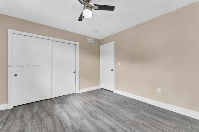 10350 SW 30th St, Miami, FL 33165 - unfurnished bedroom with wood finished floors, a closet, baseboards, and a ceiling fan