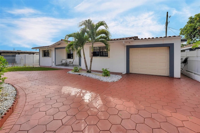 10350 SW 30th St, Miami, FL 33165 - mediterranean / spanish house with stucco siding, fence, a garage, and decorative driveway