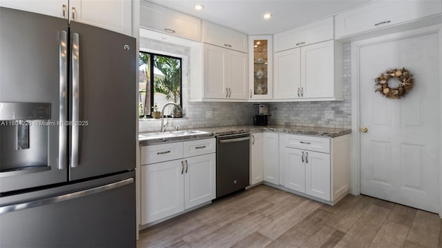 4955 NW 10th St, Coconut Creek, FL 33063 - kitchen with appliances with stainless steel finishes, a sink, white cabinets, light stone countertops, and recessed lighting