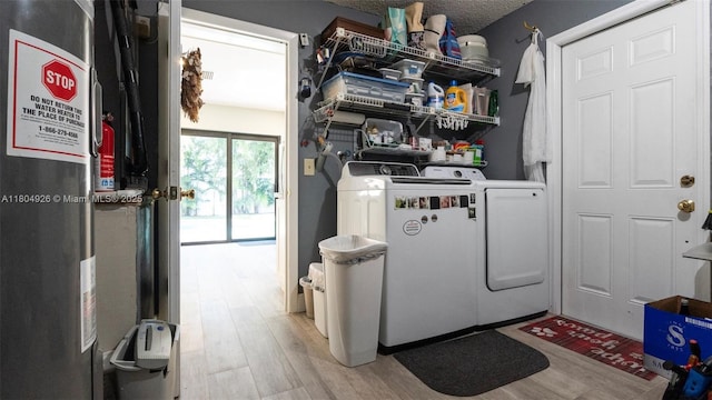 4955 NW 10th St, Coconut Creek, FL 33063 - laundry area with independent washer and dryer, electric water heater, and light wood finished floors