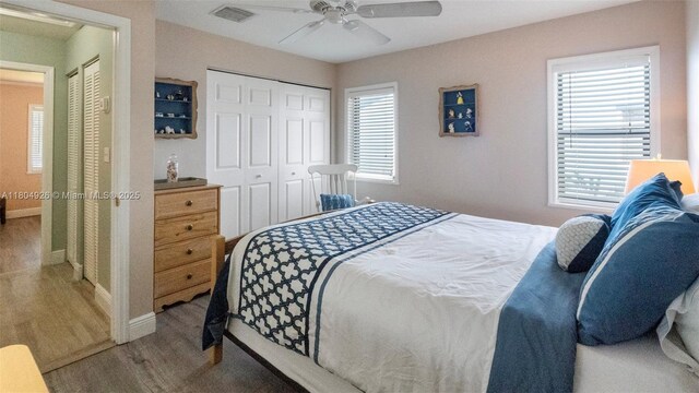 4955 NW 10th St, Coconut Creek, FL 33063 - bedroom with baseboards, wood finished floors, a closet, and multiple windows