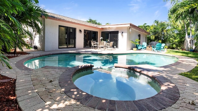 4955 NW 10th St, Coconut Creek, FL 33063 - view of swimming pool featuring a pool with connected hot tub and a patio area