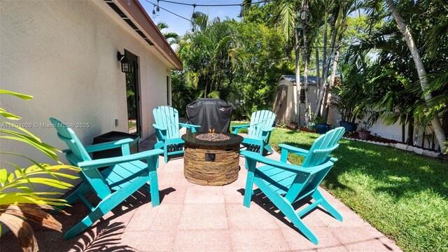4955 NW 10th St, Coconut Creek, FL 33063 - view of patio with a fire pit, a storage shed, and an outbuilding
