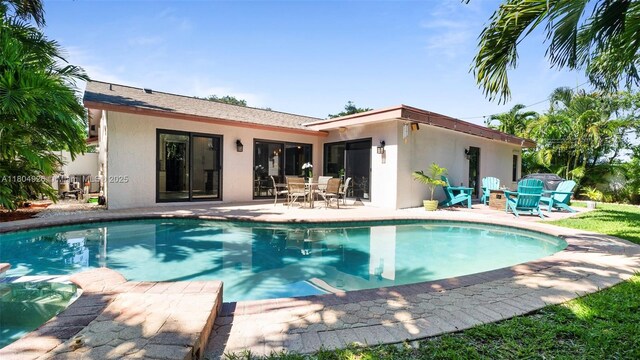 4955 NW 10th St, Coconut Creek, FL 33063 - rear view of property featuring stucco siding, a patio, and a pool with connected hot tub