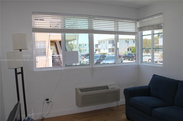 300 74th St Unit 10, Miami Beach, FL 33141 - living area with a wall mounted AC and wood finished floors