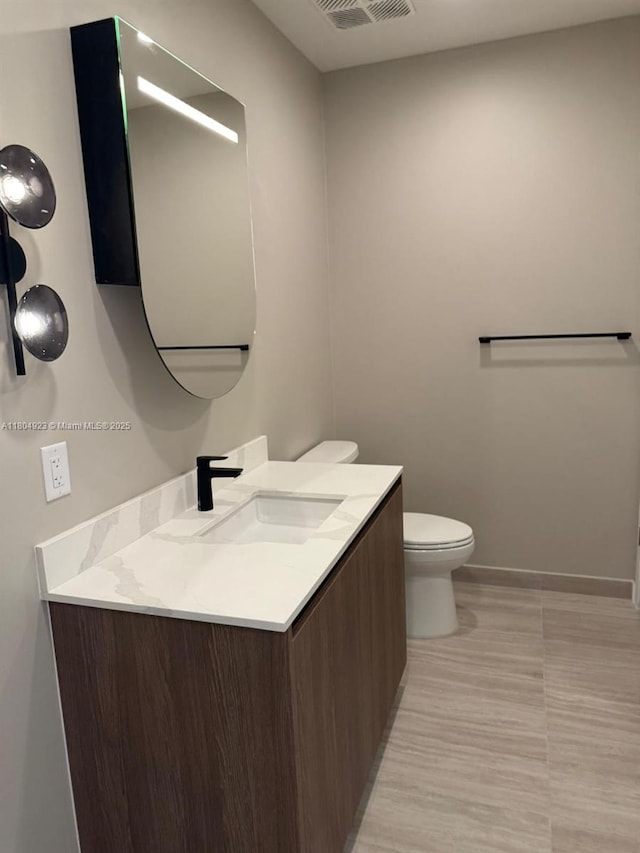 580 72 Unit Ph7, Miami Beach, FL 33141 - bathroom featuring vanity, toilet, and baseboards