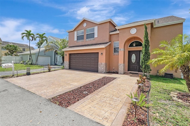 10920 SW 11th Ct, Davie, FL 33324 - view of front of house with stucco siding, an attached garage, decorative driveway, and a shingled roof