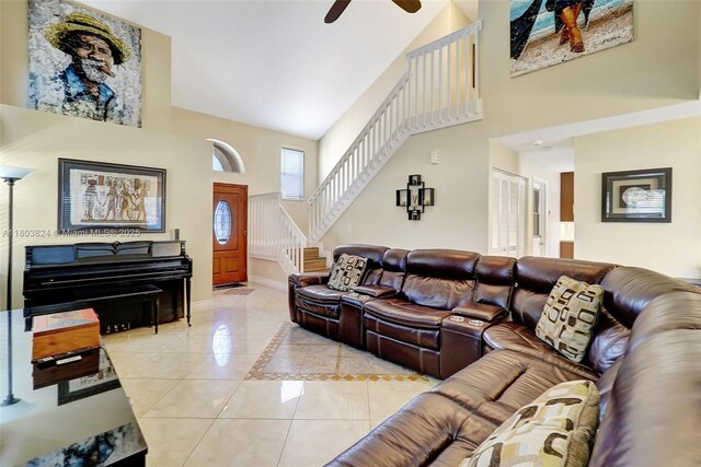 10920 SW 11th Ct, Davie, FL 33324 - living room featuring a high ceiling, light tile patterned flooring, stairs, baseboards, and a ceiling fan