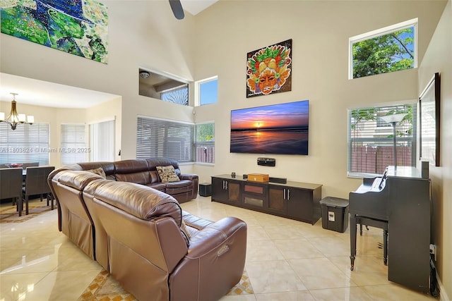 10920 SW 11th Ct, Davie, FL 33324 - living room featuring a high ceiling, a chandelier, healthy amount of natural light, and light tile patterned floors