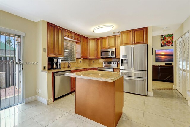 10920 SW 11th Ct, Davie, FL 33324 - kitchen with stainless steel appliances, a sink, backsplash, and light tile patterned flooring