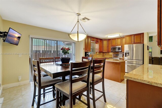 10920 SW 11th Ct, Davie, FL 33324 - dining room featuring light tile patterned floors and baseboards