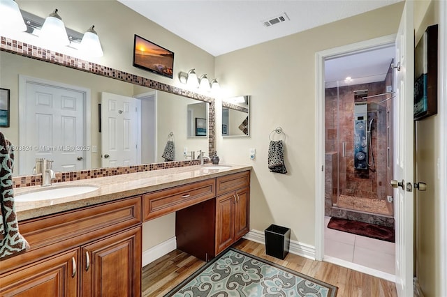 10920 SW 11th Ct, Davie, FL 33324 - full bath with a stall shower, double vanity, wood finished floors, and baseboards