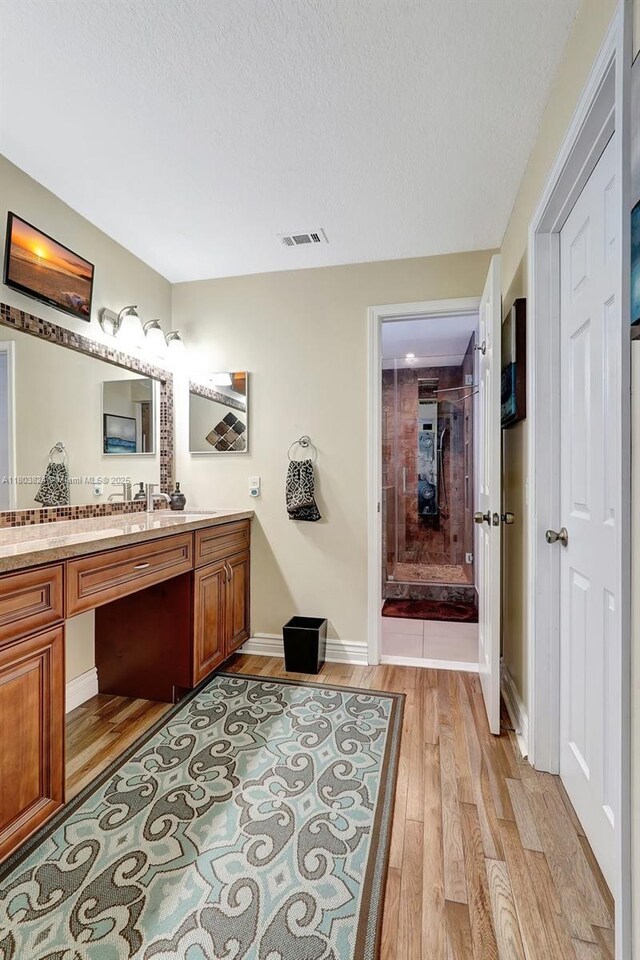 10920 SW 11th Ct, Davie, FL 33324 - bathroom with wood finished floors, vanity, a textured ceiling, and baseboards