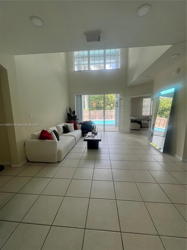 9942 SW 158th Ct, Miami, FL 33196 - living room featuring light tile patterned floors and baseboards
