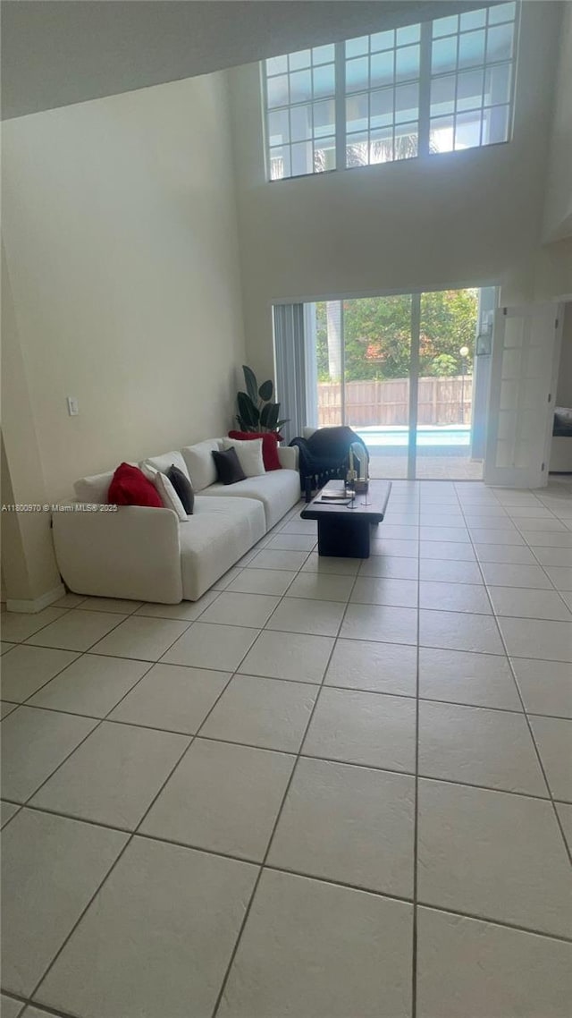 9942 SW 158th Ct, Miami, FL 33196 - living room featuring light tile patterned flooring and a towering ceiling
