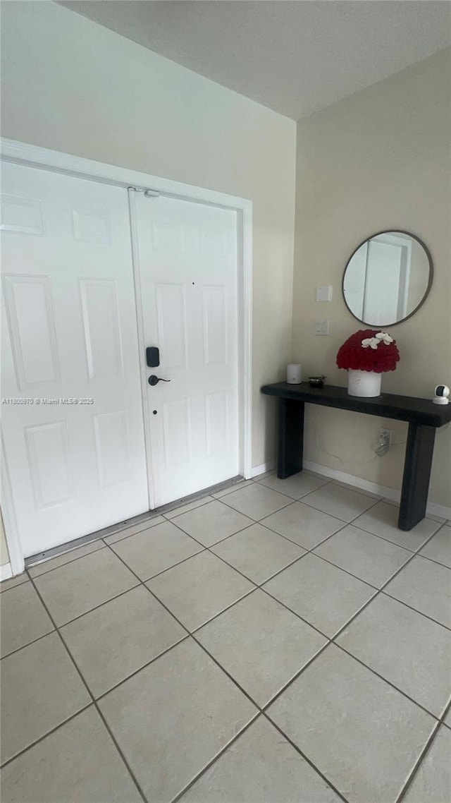 9942 SW 158th Ct, Miami, FL 33196 - foyer featuring light tile patterned floors and baseboards