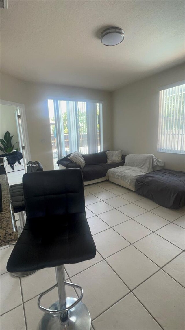 9942 SW 158th Ct, Miami, FL 33196 - living room with light tile patterned floors and a textured ceiling