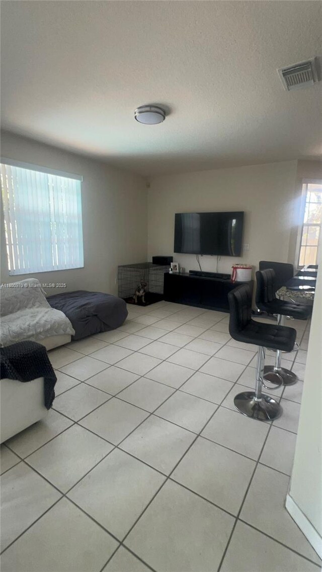 9942 SW 158th Ct, Miami, FL 33196 - living area with light tile patterned flooring and a textured ceiling